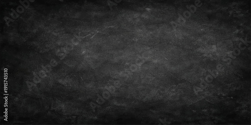 A dark grunge black and white chalkboard background with a rough grey concrete wall texture and vintage dirty paper pattern for a blank backdrop design