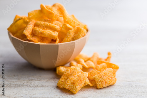 Tablou pe pânză Crispy salted chips on kitchen table.