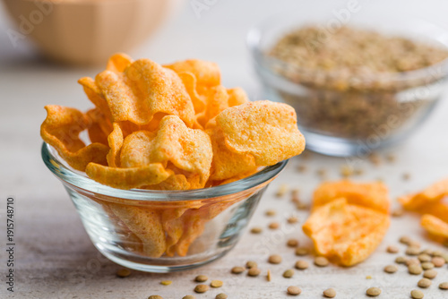 Billede på lærred Crispy lentil chips on kitchen table.
