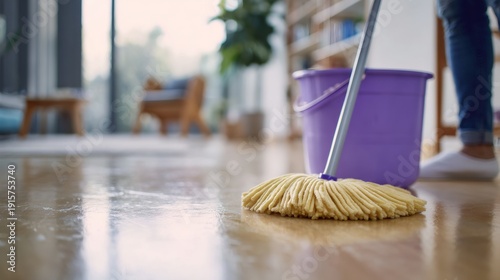 Person is cleaning a floor with a mop