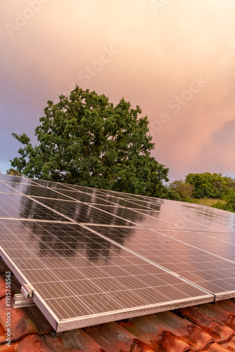 Solar panels on roof generating clean energy at sunset
