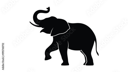 Majestic elephant silhouette walking with trunk raised high