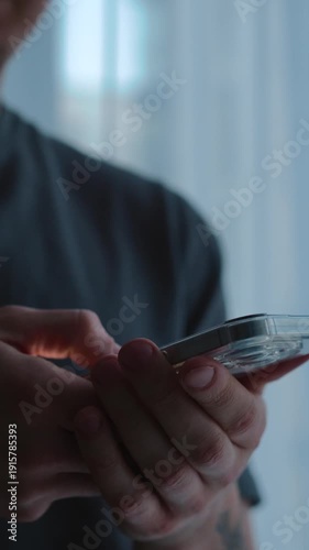 Sending a message from a smartphone.
A man clicks a mobile phone with his hands.
A close-up of a touchscreen mobile phone.