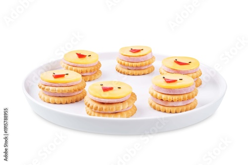 Ham sausage and cheese slices in the form of chick and crackers on a white isolated background