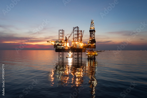 Fotografia Aerial view of offshore jack up rig in a shipyard during sunset for oil and gas exploration and production