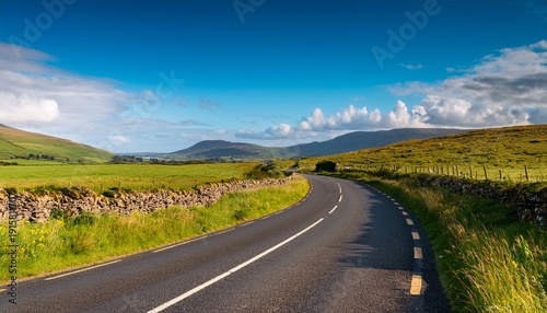A Country Road Winding Through The Summer Countryside Of Northern Ireland
