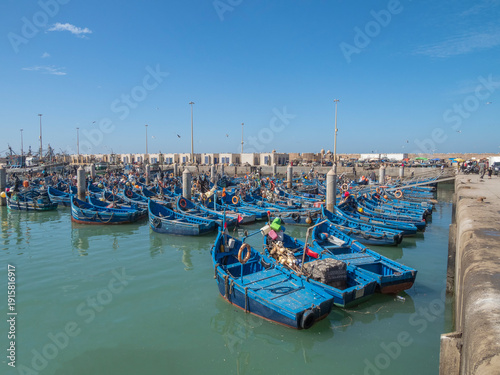 Blue fishing boats mooring at the port of The Essaouira Citadel (also known as the Skala du Port), Morocco