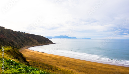Rocky coastline and sandy beach with cliffs and ocean waves. High quality photo