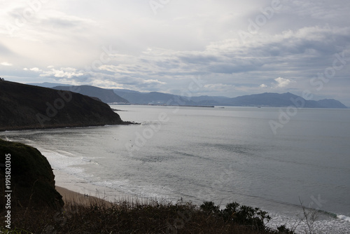 Rocky coastline and sandy beach with cliffs and ocean waves. High quality photo