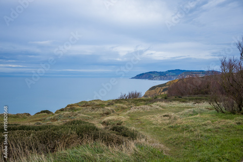 Rocky coastline and sandy beach with cliffs and ocean waves. High quality photo