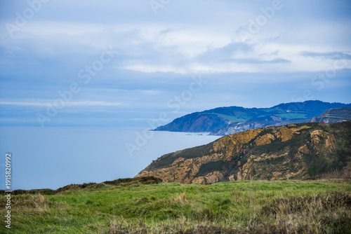 Rocky coastline and sandy beach with cliffs and ocean waves. High quality photo