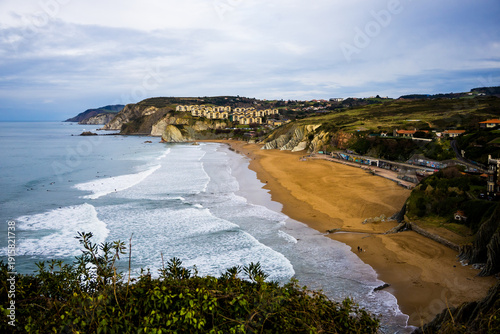 Rocky coastline and sandy beach with cliffs and ocean waves. High quality photo