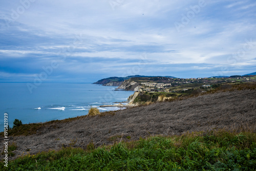 Rocky coastline and sandy beach with cliffs and ocean waves. High quality photo