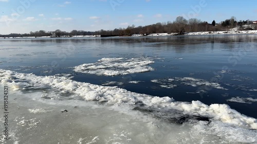 Narew River in winter, close-up of floating ice floes.