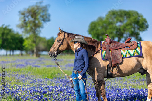 Schilderij op canvas Texas Cowgirl with Dun Quarter Horse in Texas Bluebonnets