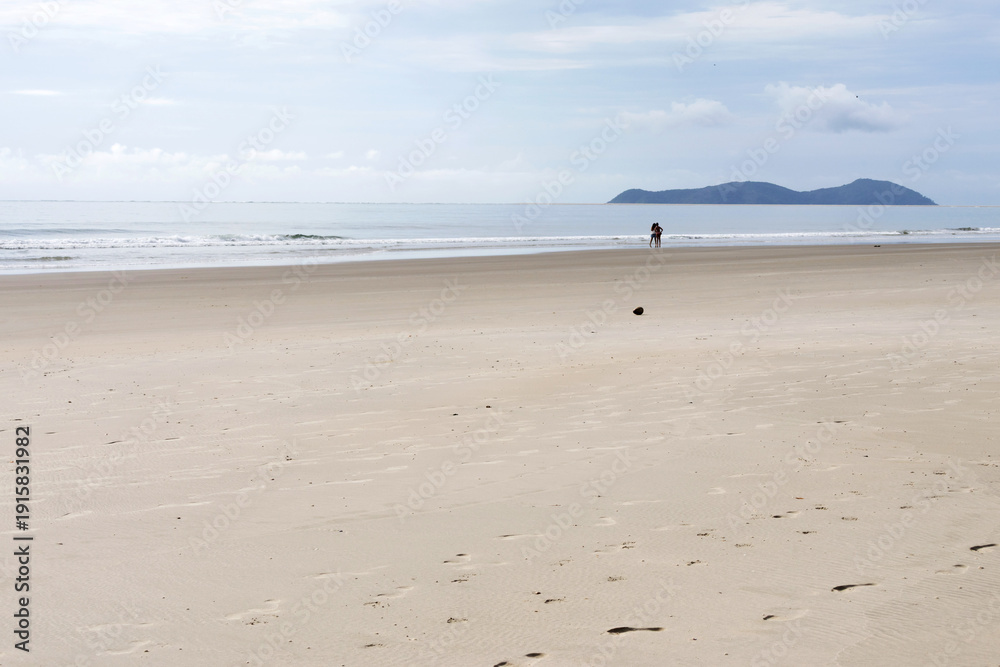 Φωτογραφία Beach landscape consisting of a wide strip of sand, the sea, mountains in the ba