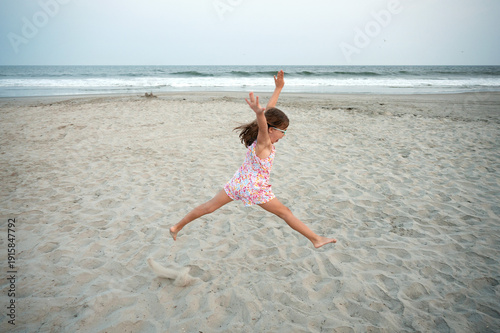 young girl dancing on the beach