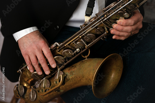Photos Close up of man's hands playing a tenor saxophone