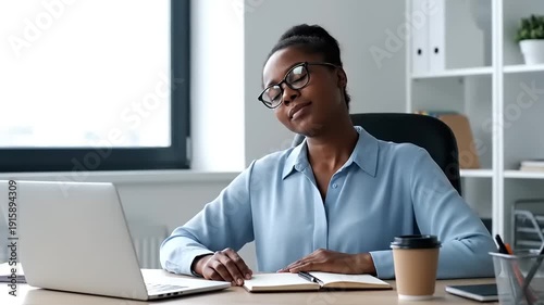 Thoughtful African American Businesswoman Meditating and Smiling at Office Desk.