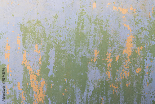 Peeling paint on the wall. Old concrete wall with cracked flaking paint. Weathered rough painted surface with patterns of cracks and peeling. Grunge texture for background and design. High resolution.