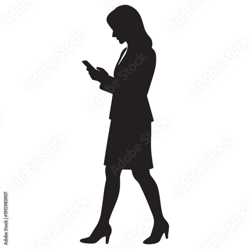 Silhouette of a woman in business attire walking while looking at her phone
