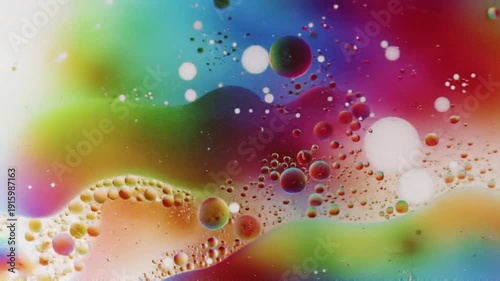 Rainbow Colored Oil Droplets on Water Surface.