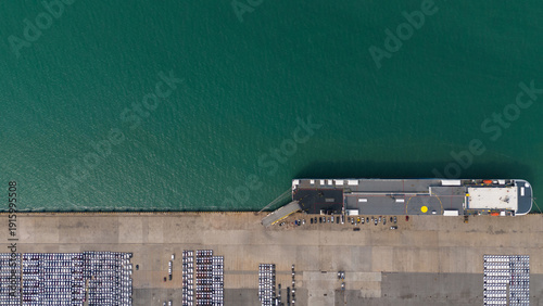 Cuadro en lienzo Top view of port, electric car shipping yard and intercontinental shipping industry