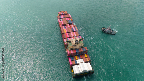 Aerial top view over international containers cargo ship at industrial import-export port prepare to load containers with big container loader ship vessel. global transportation and logistic business.