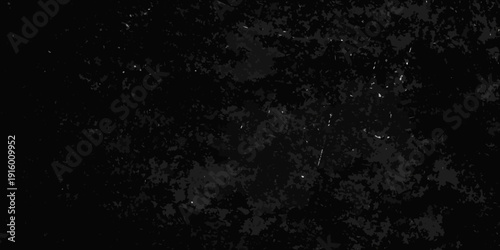 Abstract dark background with scattered grainy texture and subtle light specks