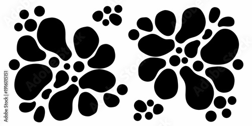 Two sets of black paw prints on a white background showcase animal tracks