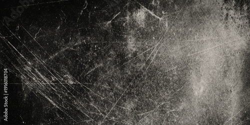 A dramatically wall textured black and white image displaying a network of scratches and dust particles across the surface