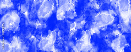 Abstract red watercolor background with soft white center and textured paint splashes. Vibrant crimson and scarlet tones blend organically, creating a dynamic artistic backdrop