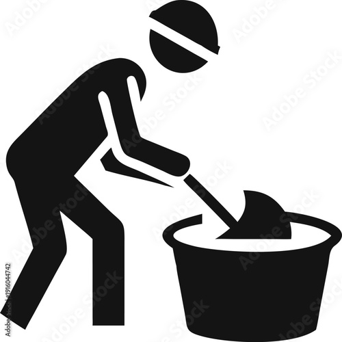 Construction worker wearing a hard hat mixes materials in a large bucket