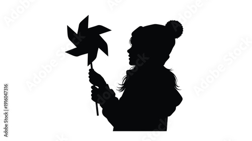 Child holding a pinwheel against a bright background silhouette