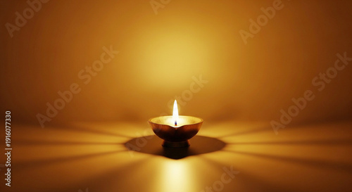 A single lit clay lamp on a reflective surface indoors