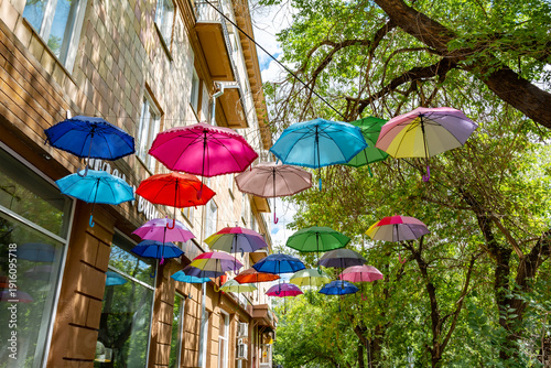 A city street installation featuring colorful umbrellas.