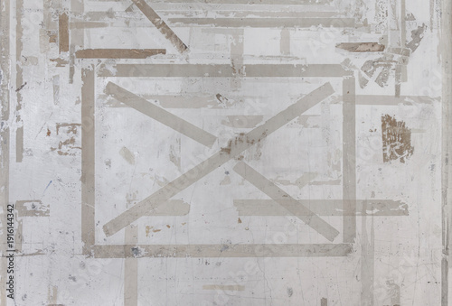 Photos A concrete wall with a grunge texture, marked by the lingering residue of adhesi