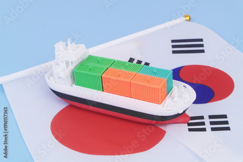 Cargo ship with many containers with Korean and Japanese flag on blue background.
