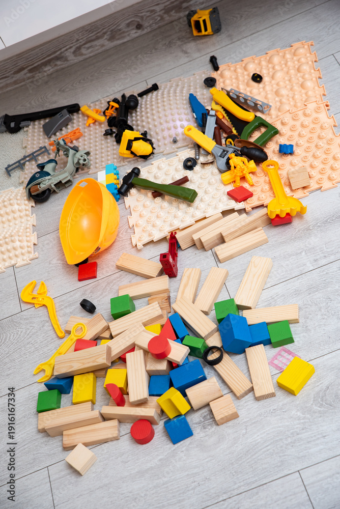 Fototapeta premium Mixed wooden blocks builder toys and orthopedic mats on floor in kids room