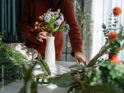 Flower shop owner arranging flowers