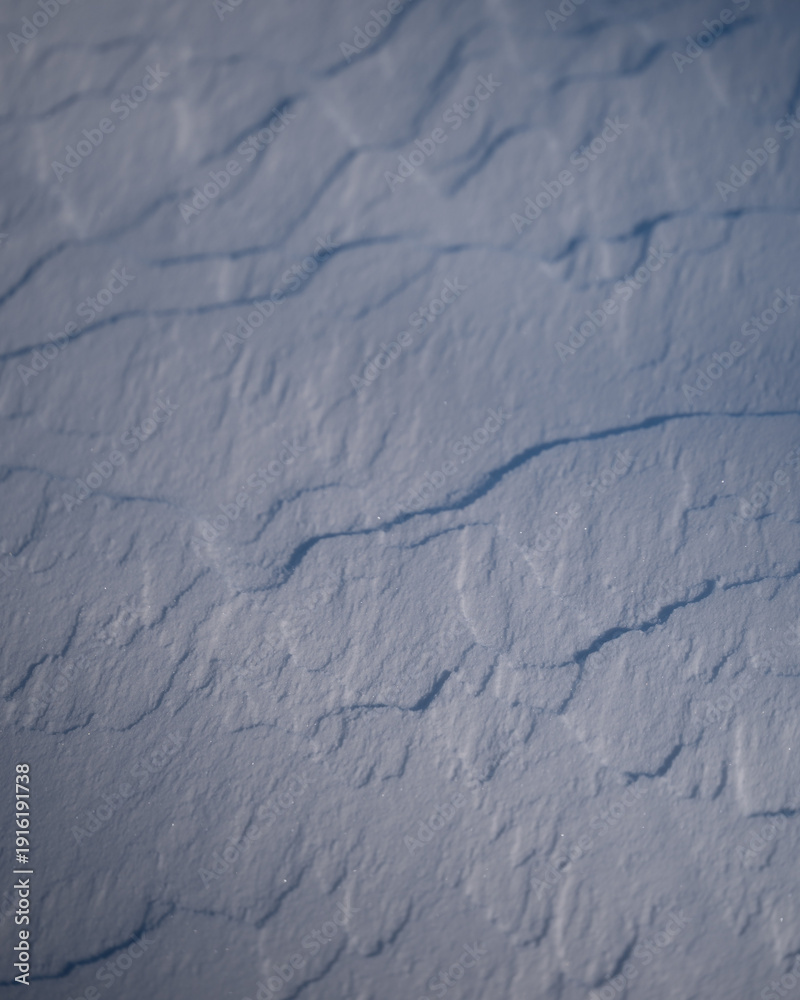 Fototapeta premium Snowy patterns on surface of ground during winter