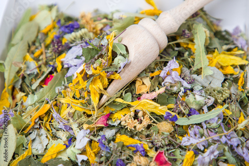 Dried herbal tea with wooden scoop, close-up. Herbal medicine.
