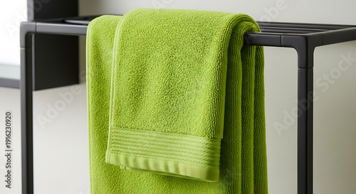 Wallpaper Mural Vibrant Green Cotton Towel Hanging on Modern Black Minimalist Drying Rack in Bright Bathroom Torontodigital.ca