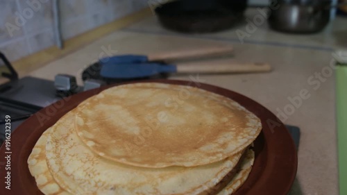 Crepe Cooking on Stove with Stack Nearby
