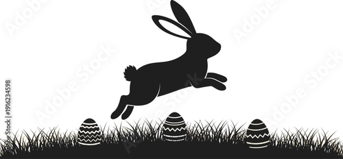 Black silhouette of an energetic rabbit leaping over decorated easter eggs hidden in tall grass during springtime celebration