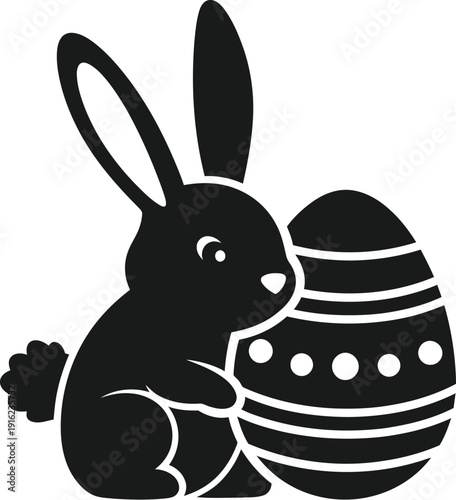 Simple black silhouette icon depicting a cute little bunny rabbit tenderly embracing a decorated Easter egg ready for spring celebration