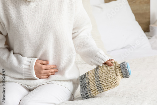 Woman with hot water bottle...
