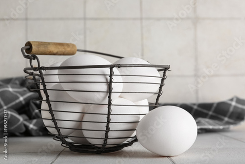 White eggs in rustic wire b...