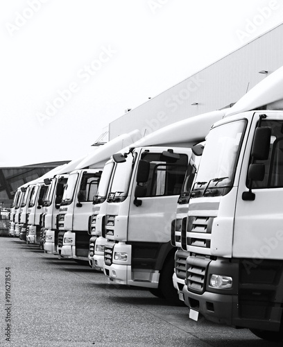 lorries parked up outside a company's car parking area no people stock photo