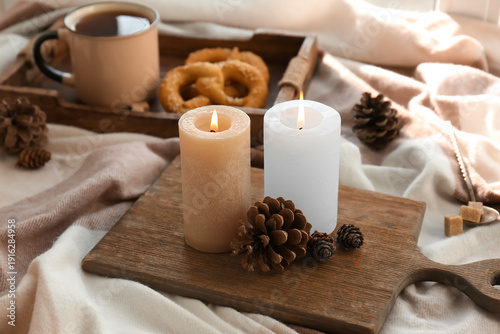 Wallpaper Mural Wooden board, burning candles and fir cones on plaid as background, closeup Torontodigital.ca